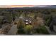 Stunning aerial view of a home with a lake view, three-car garage, and mature trees at 3 White Pelican Cir, Thornton, CO 80241