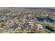 Expansive aerial view of a community with homes nestled among trees and a serene lake at 3 White Pelican Cir, Thornton, CO 80241