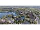 Picturesque aerial view of homes nestled around a serene lake, showcasing the community's lush landscaping at 3 White Pelican Cir, Thornton, CO 80241