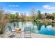 Scenic backyard with a peaceful pond, complete with a dock and picnic basket creating a relaxing retreat at 3 White Pelican Cir, Thornton, CO 80241