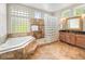 Stunning bathroom with tub, a glass block shower, and granite counters at 3 White Pelican Cir, Thornton, CO 80241