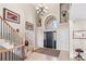 Grand foyer with soaring ceilings, a staircase, chandelier, and large arched window, creating a bright entry at 3 White Pelican Cir, Thornton, CO 80241