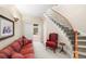 Welcoming foyer with staircase and comfortable seating, creating a warm entry at 3 White Pelican Cir, Thornton, CO 80241