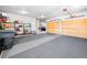 Expansive garage area features two garage doors with convenient shelving and storage at 3 White Pelican Cir, Thornton, CO 80241