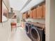 Efficient laundry room featuring modern appliances and ample storage cabinets at 3 White Pelican Cir, Thornton, CO 80241