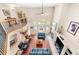 Open living room boasting a fireplace, floor-to-ceiling windows with serene view, and hardwood floors at 3 White Pelican Cir, Thornton, CO 80241