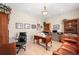 Spacious home office featuring built-in bookshelves and a comfortable leather couch at 3 White Pelican Cir, Thornton, CO 80241
