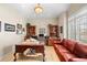 Bright home office featuring built-in bookshelves and a comfortable red leather couch at 3 White Pelican Cir, Thornton, CO 80241