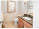 Charming powder room featuring elegant vanity with granite countertop and decorative mirror at 3 White Pelican Cir, Thornton, CO 80241