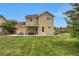 A spacious backyard with a well-maintained lawn and a covered patio, perfect for outdoor entertaining at 6260 E 114Th Ave, Thornton, CO 80233