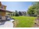 Lush backyard with a covered patio and manicured lawn, perfect for outdoor entertaining at 6260 E 114Th Ave, Thornton, CO 80233