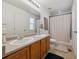En-suite bathroom features double sinks and bath shower at 6260 E 114Th Ave, Thornton, CO 80233