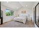 Bright bedroom with neutral tones, large window, and carpeted flooring at 6260 E 114Th Ave, Thornton, CO 80233