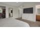 Spacious bedroom with a large TV, neutral colors and views of the en-suite bathroom and walk-in closet at 6260 E 114Th Ave, Thornton, CO 80233
