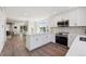 Open-concept kitchen and dining area featuring stainless appliances and stone backsplash at 6260 E 114Th Ave, Thornton, CO 80233