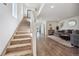 Bright living room featuring hardwood floors, an open staircase, and stylish decor, perfect for modern living at 6260 E 114Th Ave, Thornton, CO 80233