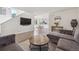 Spacious living room with hardwood floors, modern decor, and an open layout, seamlessly connecting to the dining area at 6260 E 114Th Ave, Thornton, CO 80233