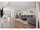 Open-concept living room with hardwood floors, modern decor, and seamless transition to the kitchen, ideal for entertaining at 6260 E 114Th Ave, Thornton, CO 80233
