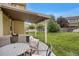 Covered patio with outdoor seating area overlooking a lush, green backyard at 6260 E 114Th Ave, Thornton, CO 80233