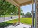 Serene front porch view with a charming flowerbed, overlooking a green neighborhood park and grassy walkway at 6260 E 114Th Ave, Thornton, CO 80233