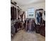 Spacious walk-in closet with ample hanging space and natural light from a window at 6260 E 114Th Ave, Thornton, CO 80233