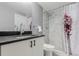 Well-lit bathroom featuring a modern vanity with sleek fixtures and a shower with white subway tile at 720 16Th St # 311, Denver, CO 80202