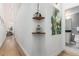 Hallway leading to a bathroom, featuring hardwood floors, neutral walls, and modern artwork at 720 16Th St # 311, Denver, CO 80202