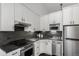 Sleek kitchen with stainless steel appliances, dark countertops, and modern cabinetry at 720 16Th St # 311, Denver, CO 80202
