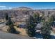 Aerial view of a well-maintained home with mature trees and a mountain backdrop at 2605 Crabapple Ct, Golden, CO 80401