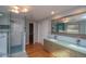 A renovated bathroom featuring a glass shower, dual sinks, and modern fixtures at 2605 Crabapple Ct, Golden, CO 80401