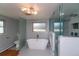 A modern bathroom featuring a soaking tub, glass shower and stylish tile at 2605 Crabapple Ct, Golden, CO 80401