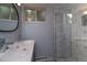Modern bathroom features a glass shower with decorative tile and a sleek double vanity at 2605 Crabapple Ct, Golden, CO 80401