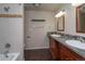 Bright bathroom with double vanity, granite countertops, tile flooring, and shower-tub combo at 2605 Crabapple Ct, Golden, CO 80401