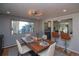 An open dining room showcases a wooden table setting and seamless flow to the kitchen and living area at 2605 Crabapple Ct, Golden, CO 80401