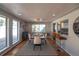 Sunlit dining room with hardwood floors, modern chandelier, and seating for six, perfect for Gathering meals at 2605 Crabapple Ct, Golden, CO 80401