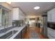 Bright, open kitchen with stainless steel appliances, white cabinets, and hardwood floors at 2605 Crabapple Ct, Golden, CO 80401