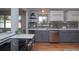 Stylish kitchen with stainless steel appliances, grey backsplash, under cabinet lighting, and hardwood floors at 2605 Crabapple Ct, Golden, CO 80401