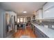Modern kitchen featuring stainless steel appliances, white cabinets, gray lower cabinets, and hardwood floors at 2605 Crabapple Ct, Golden, CO 80401