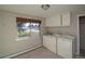 Functional laundry room featuring a washer, dryer, and storage cabinets at 2605 Crabapple Ct, Golden, CO 80401