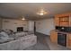 A spacious room with a fireplace, wet bar, and comfortable gray sofa at 2605 Crabapple Ct, Golden, CO 80401