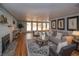 Cozy living room with hardwood floors, fireplace, large windows, and neutral color scheme for comfort at 2605 Crabapple Ct, Golden, CO 80401