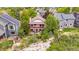 Overhead shot of a home with a balcony situated atop a rocky hillside with lush trees at 473 Somerset Dr, Golden, CO 80401