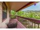 Enjoy mountain views from the private covered balcony with seating area at 473 Somerset Dr, Golden, CO 80401