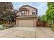 Charming two-story home featuring an attached two-car garage and a meticulously landscaped front yard at 473 Somerset Dr, Golden, CO 80401