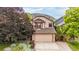 Charming two-story home featuring an attached two-car garage and a meticulously landscaped front yard at 473 Somerset Dr, Golden, CO 80401