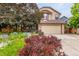Charming two-story home featuring a lush front yard and attached two-car garage at 473 Somerset Dr, Golden, CO 80401