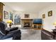 Inviting living room with carpet, fireplace, television, and windows at 473 Somerset Dr, Golden, CO 80401
