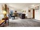Cozy living room with carpet, fireplace, two recliners, and plenty of natural light at 473 Somerset Dr, Golden, CO 80401