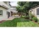 Expansive backyard with lush grass, a charming patio, and mature trees, perfect for outdoor living at 1272 S Milwaukee St, Denver, CO 80210