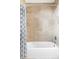 Shower and bathtub with tiled walls and a decorative curtain at 1272 S Milwaukee St, Denver, CO 80210
